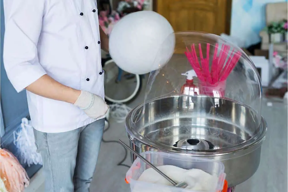 A person making cotton candy